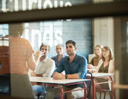 Shot of a group of businesspeople sitting in the boardroom during a presentation